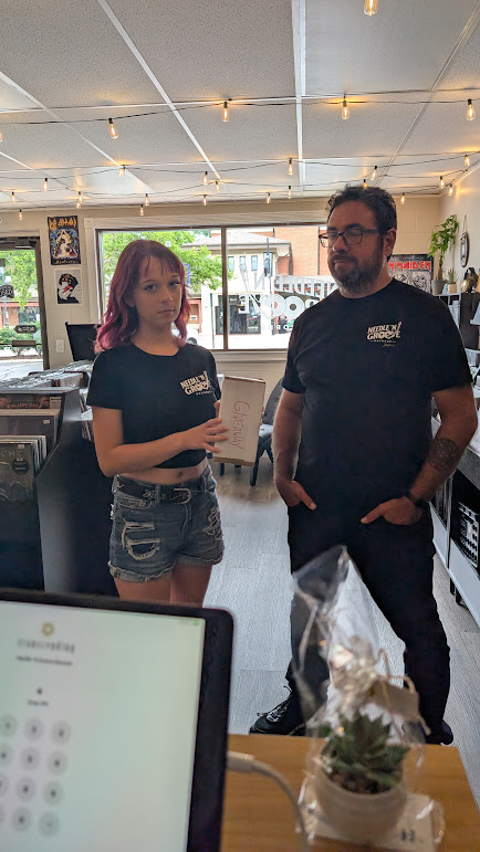Mike Ramirez and his daughter Reagan inside Needle 'N Groove Records